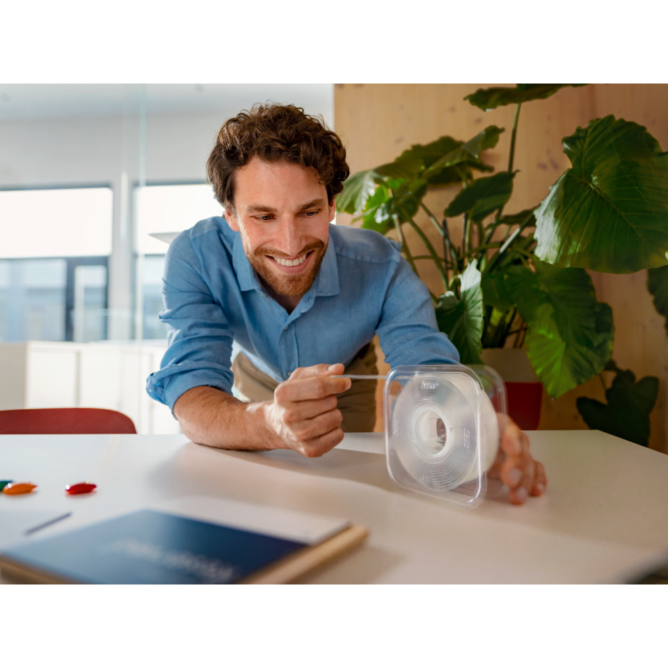 man, office, workspace, plastic container, 3D printer spool?